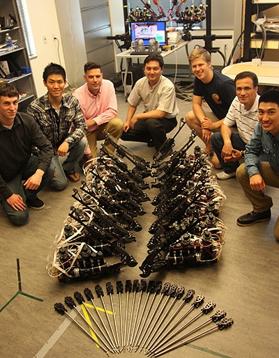 Researchers from the University of California, Santa Cruz, pose with Raven II surgical robots in a photo from 2012. Subsequent work by the researchers uncovered ways the robots could be hacked. (Photo by Carolyn Lagattuta)