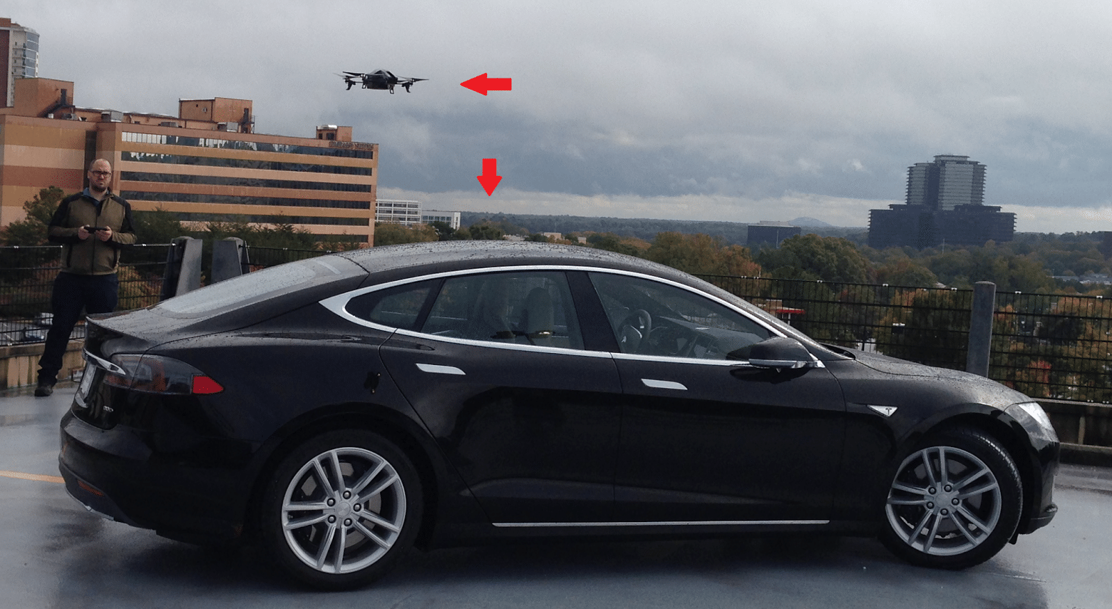 Security expert Rob Graham flies a Parrot AR Drone next to his Tesla Model S. Both devices use the same software to connect to and communicate over wireless networks. 