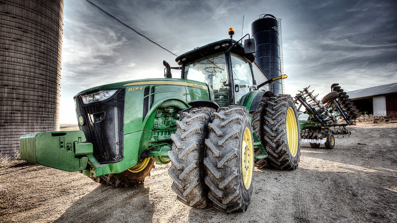 Modern tractors, like this John Deere 8235 R, contain sophisticated hardware and software. But farmers are finding that a 1990s era copyright protection law prevents them from repairing them when they break. 