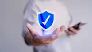 Image man holding shield with checkmark.